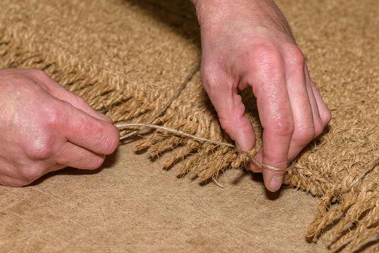 We tie the edges in by hand to stop the mat fraying. 