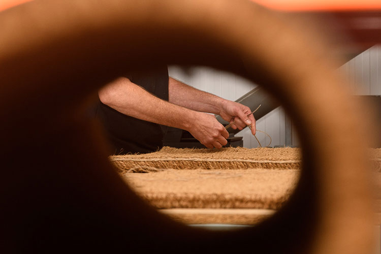 Hand Stitching a Coir Mat in our workshop